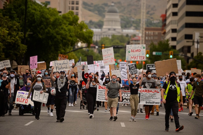 (Trent Nelson  |  The Salt Lake Tribune) People march against police brutality in Salt Lake City on Saturday, June 13, 2020.