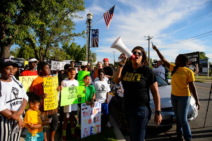 (Trent Nelson  |  The Salt Lake Tribune)
Lex Scott leads chants at a protest organized by Black Lives Matter and other groups at the Woods Cross Police Department on Friday June 14, 2019. The rally was to show support for DJ Hrubes, a 10-year-old black child who was held at gunpoint by a police officer last week while playing in his grandmother's front yard.