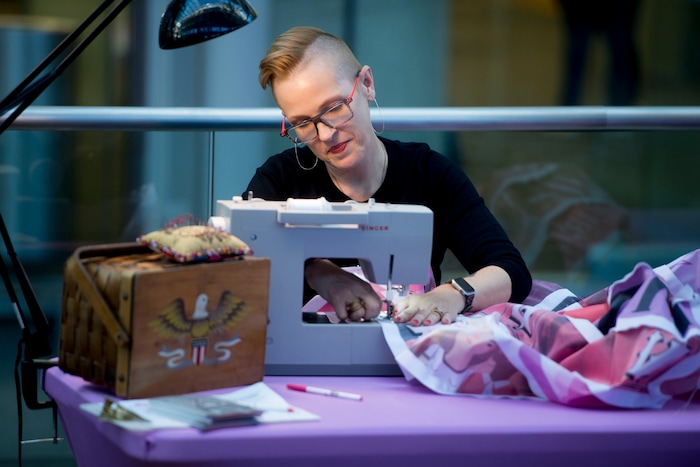 (Jeremy Harmon  |  The Salt Lake Tribune) Artist Marilyn Artus sews a stripe created by Jann Haworth onto the Her Flag project during an event at the downtown library in Salt Lake City on Wednesday, Nov. 6, 2019.