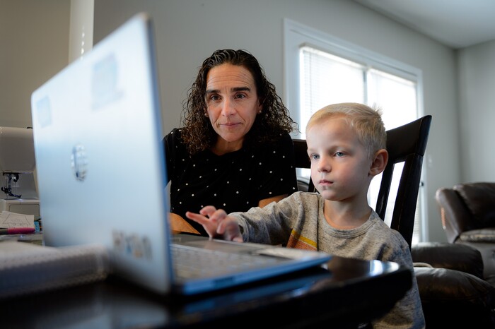(Trent Nelson  |  The Salt Lake Tribune) Jeannette Bowen works with her son Sam on his online schoolwork at home in Murray on Wednesday, Jan. 13, 2021.