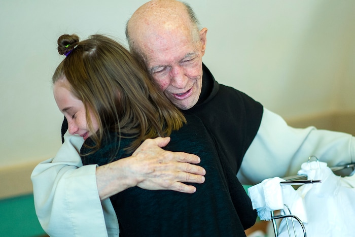 (Chris Detrick  |  The Salt Lake Tribune)  "Father Patrick" Boyle hugs Erin Vore, 12, of Farr West, in the bookstore and gift shop at the Abbey of Our Lady of the Holy Trinity in Huntsville on Wednesday, Aug. 23, 2017.