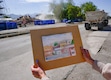(Francisco Kjolseth  | The Salt Lake Tribune) Anna Moore, a local landscape painter and “protector of all things historic, beautiful and wild,” is saddened as she holds up a painting she made years ago of the old Utah Pickle Company building as a developer tears down the building at 741 S 400 West on Thursday, May 22, 2025.