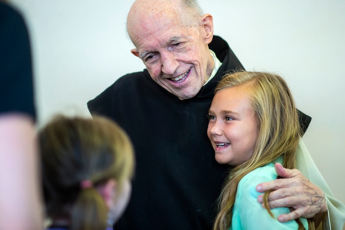 (Chris Detrick  |  The Salt Lake Tribune)  "Father Patrick" Boyle hugs Ally Vore, 10, of Farr West, in the bookstore and gift shop at the Abbey of Our Lady of the Holy Trinity in Huntsville on Wednesday, Aug. 23, 2017.